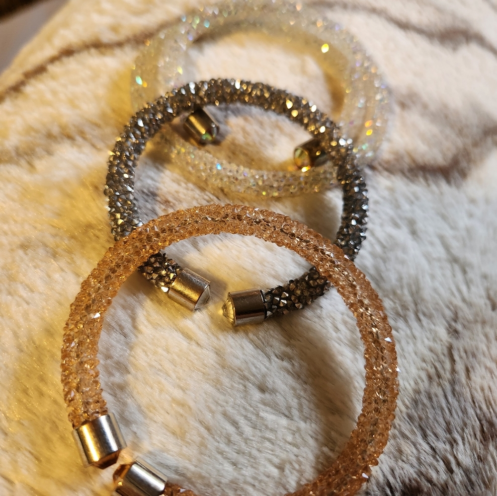 Set of 3 crystal design slide on bracelets.   Silver tone. Fun for any outfit!